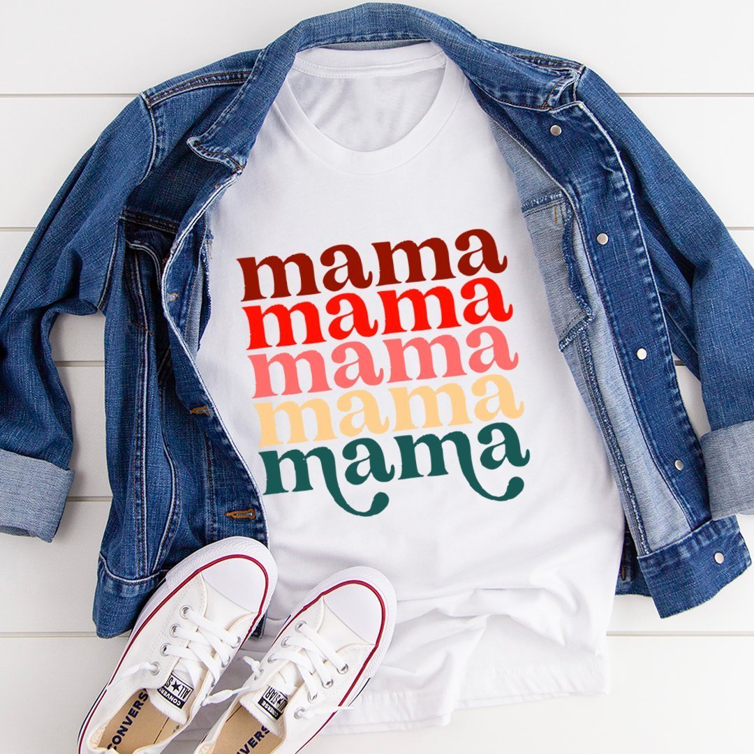 Stylish Mama Vintage Colors T-Shirt laid flat with a denim jacket and sneakers, showcasing a bold multicolored 'mama' print in a casual yet chic setup.