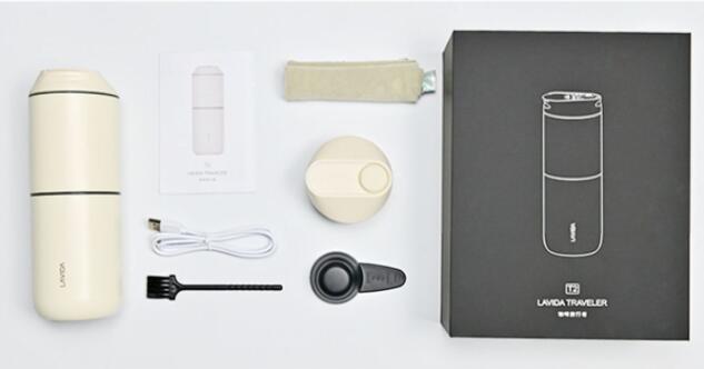 Collection of travel mug accessories including a mug, power adapter, and box on a light gray background.