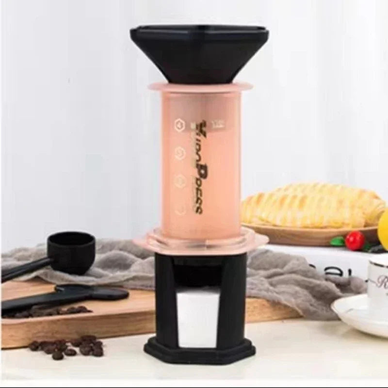 Coffee brewing device on a kitchen counter with bread and coffee beans in the background