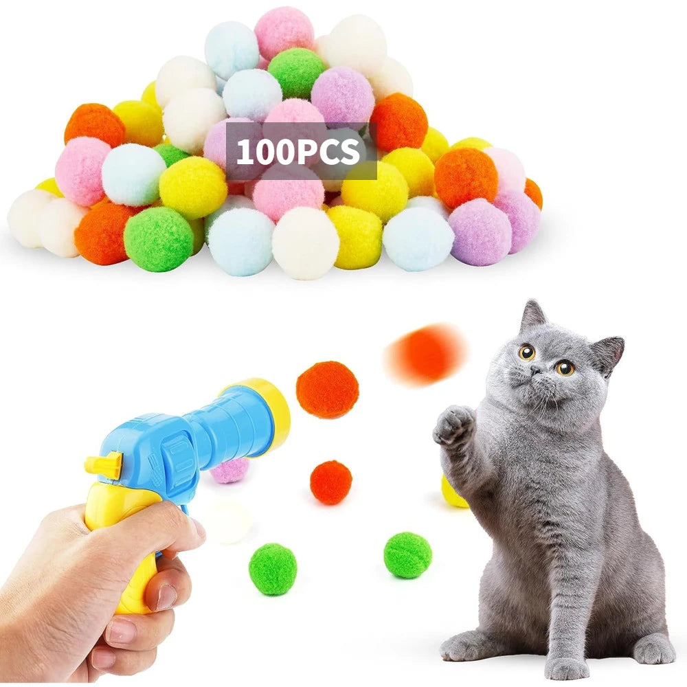 Colorful cat toy with a gun and scattered balls, featuring a cat on a white background.