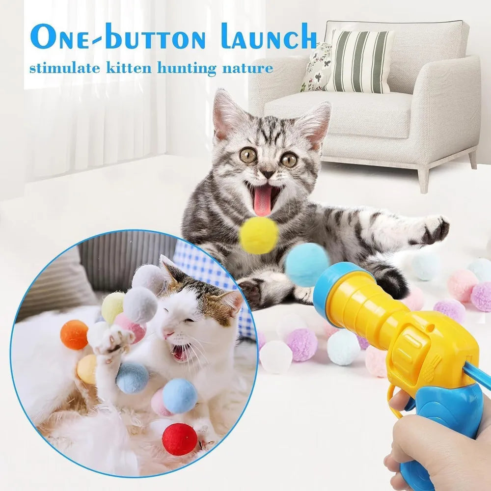 Cat playing with a toy gun that shoots colorful balls, with text 'One-button launch stimulate kitten hunting nature' above.