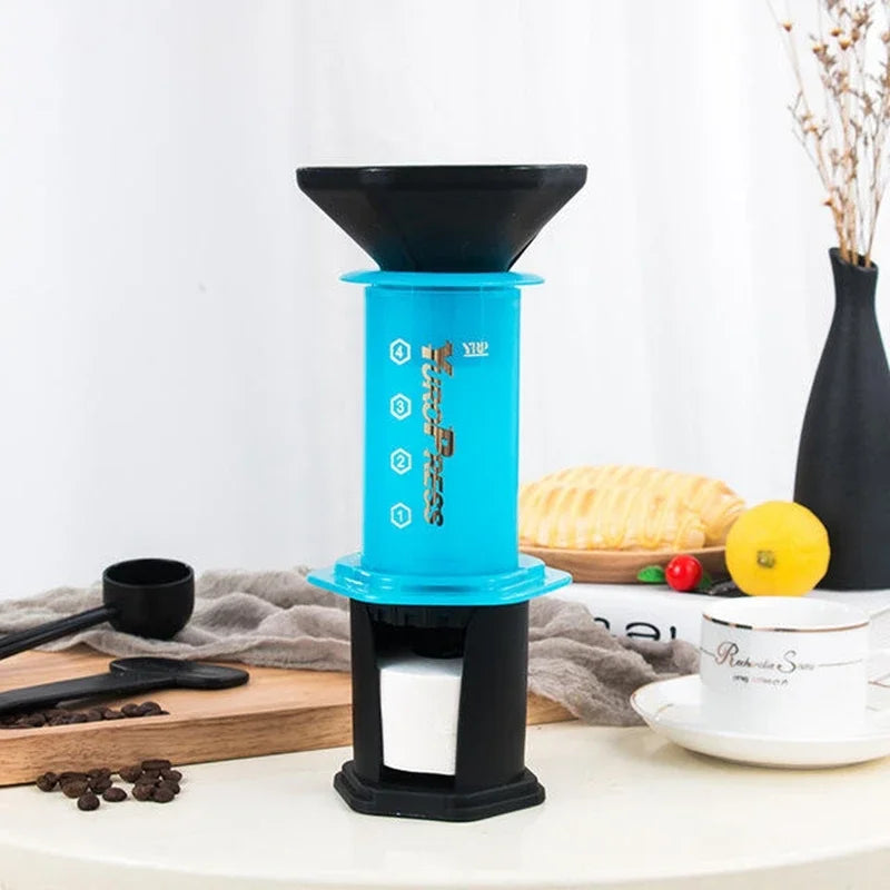 Blue and black coffee maker on a kitchen counter with a white background