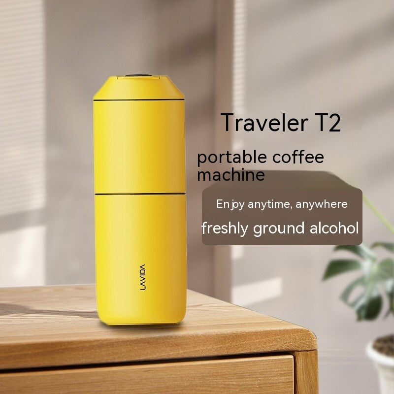 Yellow portable coffee machine on a wooden surface with a blurred background