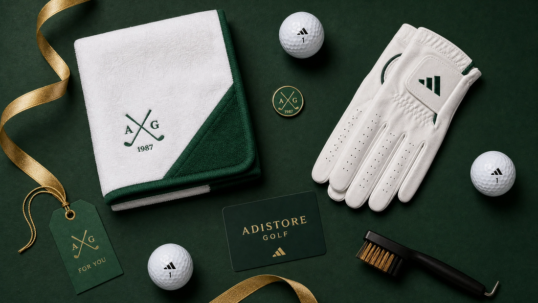 Golf gifts for men UK — golf towel, gloves, ball marker, groove brush and Adistore Golf gift card arranged on forest green background