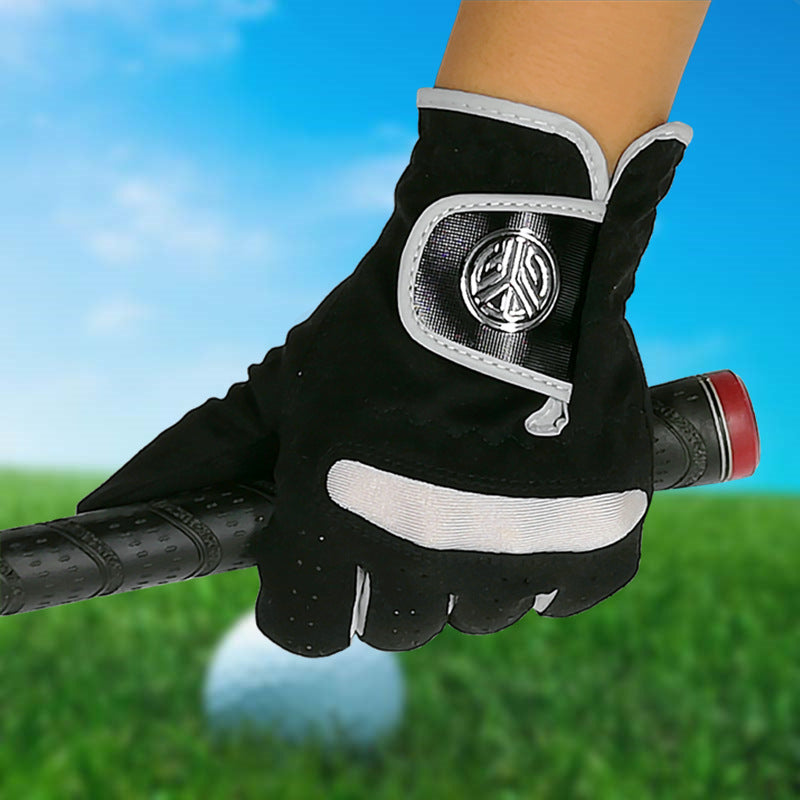 Golf gloves UK — Black wear resistant grip gloves on hand on a blured grass background.