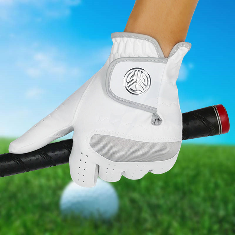 Golf gloves UK — White wear resistant grip glove on hand on blured grass background.