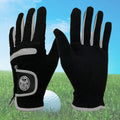Golf gloves UK — two black wear resistant grip gloves with a golf ball on grass .