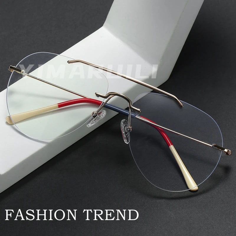 Rimless eyeglasses with red and gold accents on a dark surface, labeled 'FASHION TREND'.