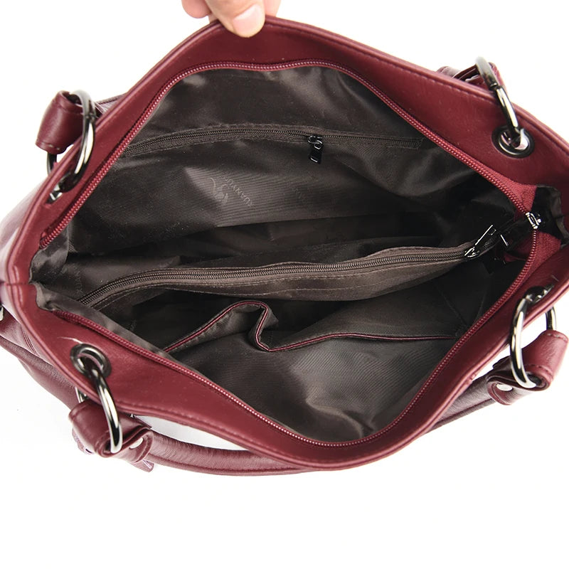Red handbag with open interior on a white background