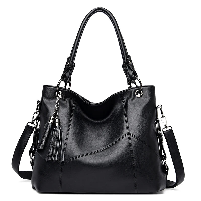 Black leather handbag with tassels on a white background