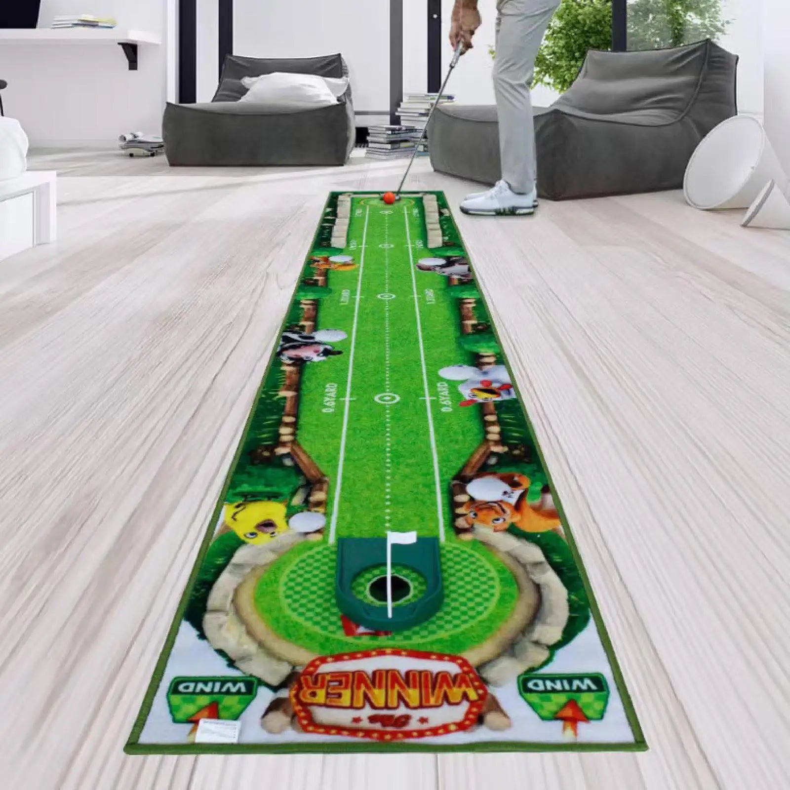 Green putting green mat with golf accessories on a light wood floor.