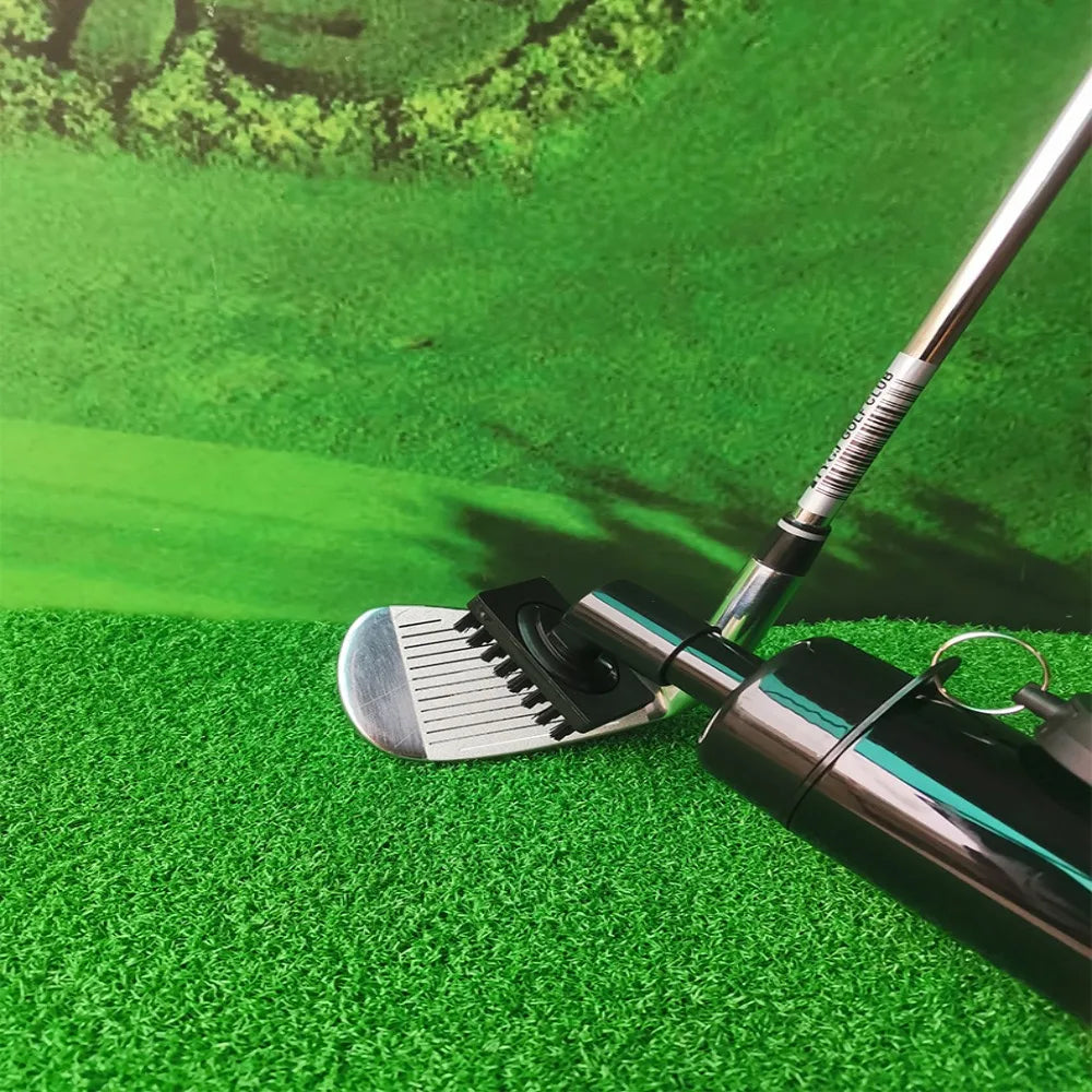 Golf club on a green surface with grass in the background
