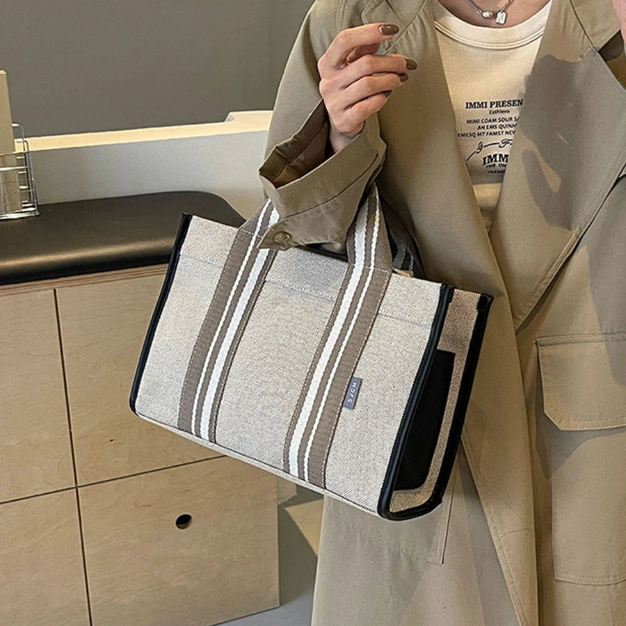 Person holding a striped bag in a kitchen setting