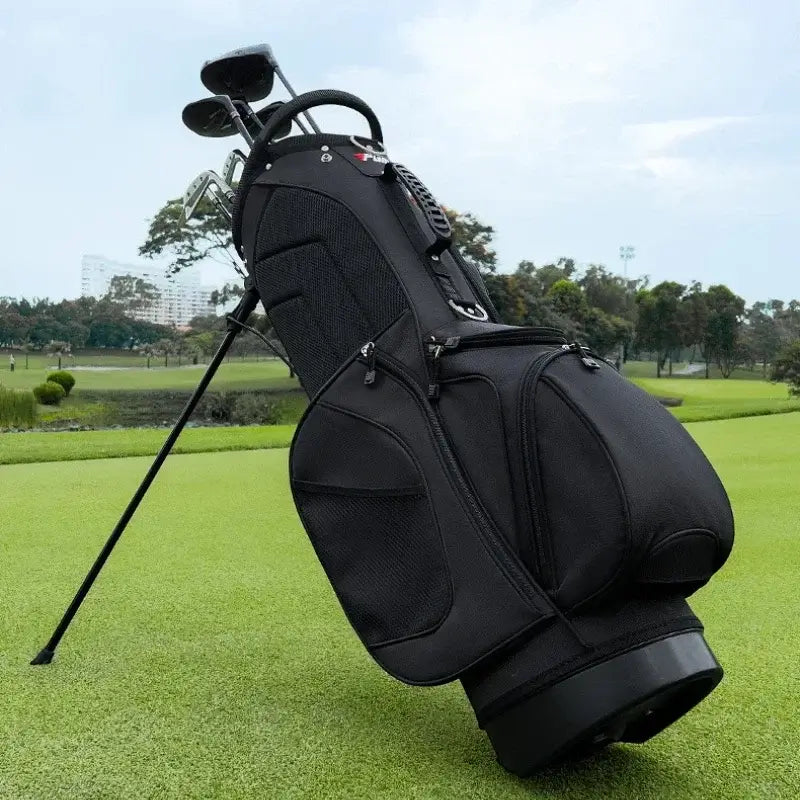 Black golf bag with clubs on a grassy field