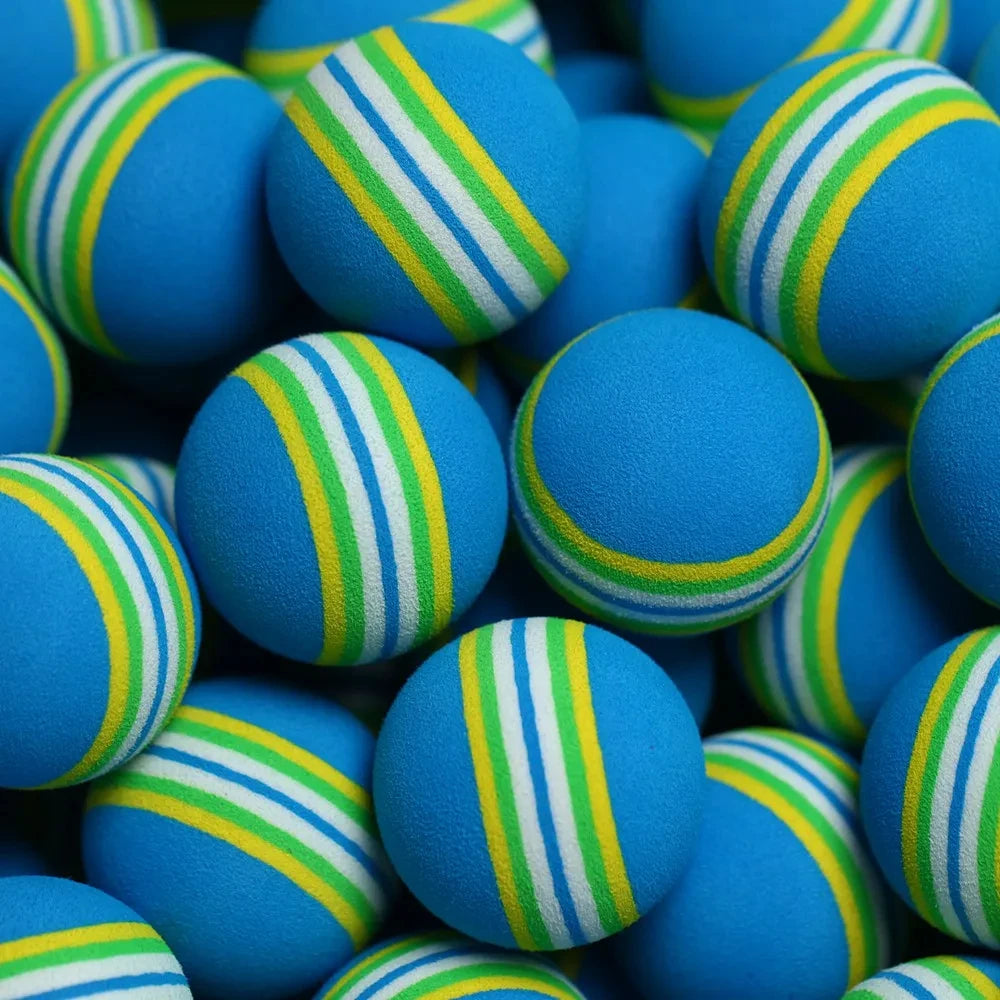 Blue foam golf balls UK with green and yellow stripes arranged in a pile
