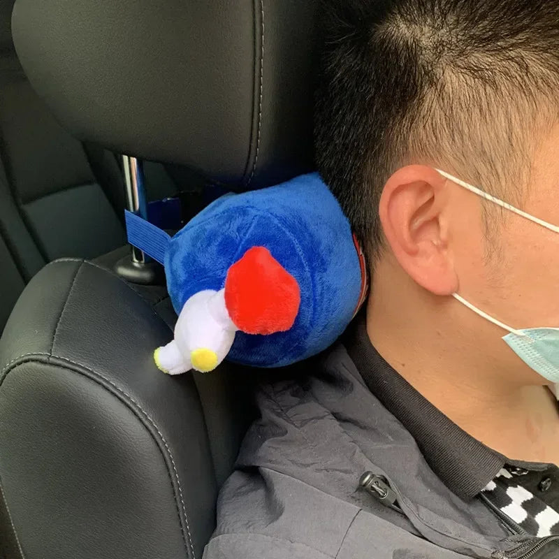 Person in a car with a blue plush toy resembling a cartoon character on their head.