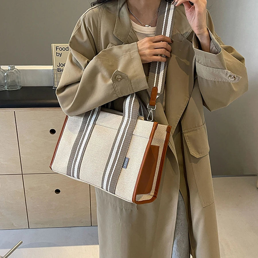 Person holding a striped tote bag in a kitchen setting