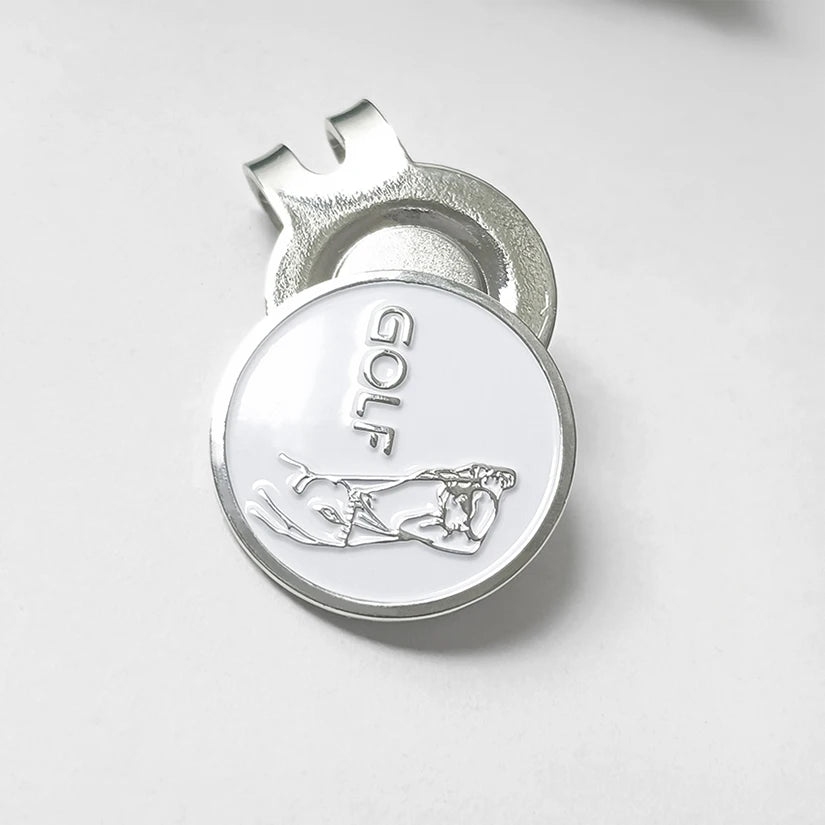 Silver golf ball marker UK with 'GOLF' engraved on a white background