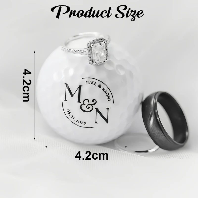 Personalised golf balls UK - Product size diagram showing two rings on a white golf ball with printed dimensions. One ring is a silver-toned diamond engagement-style ring, and the other is a matte black band.