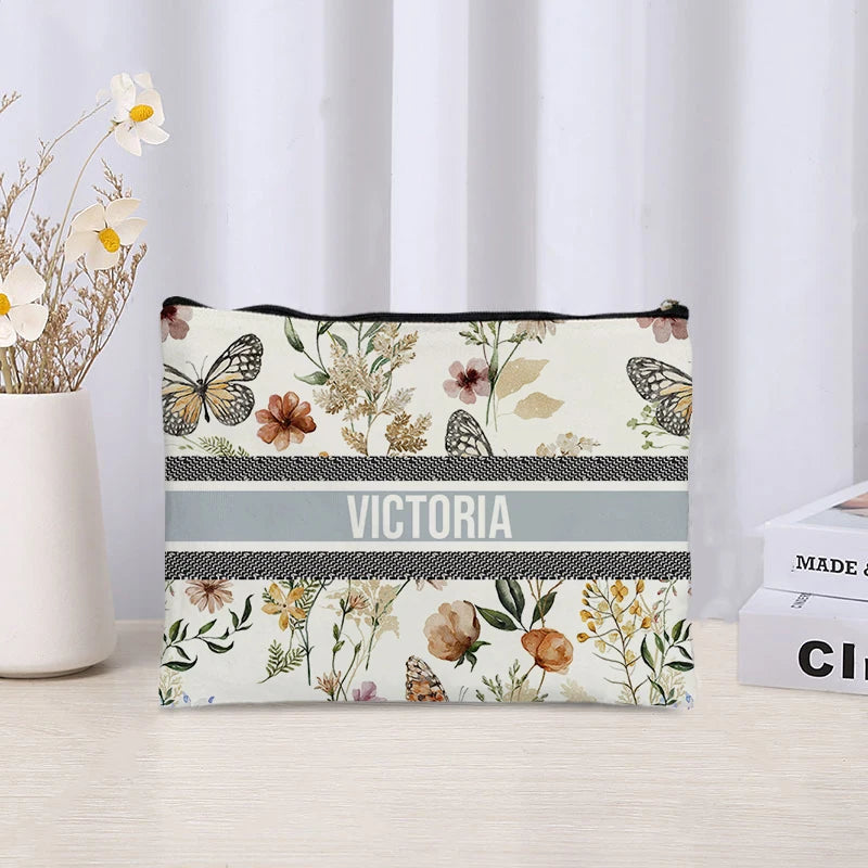 Floral-patterned pouch with 'Victoria' branding on a light surface.