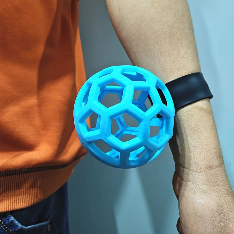 golf swing trainer UK - Blue textured ball held by a person against a light blue background