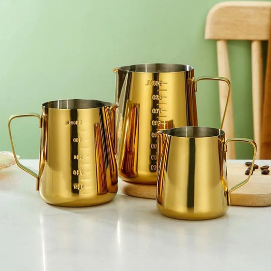 Stainless steel set of three pitcher coffee frothing jugs.