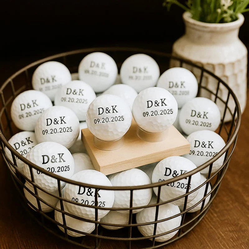 Personalised golf balls UK - Personalized white golf balls with the names 'D&K' and the date '09.20.