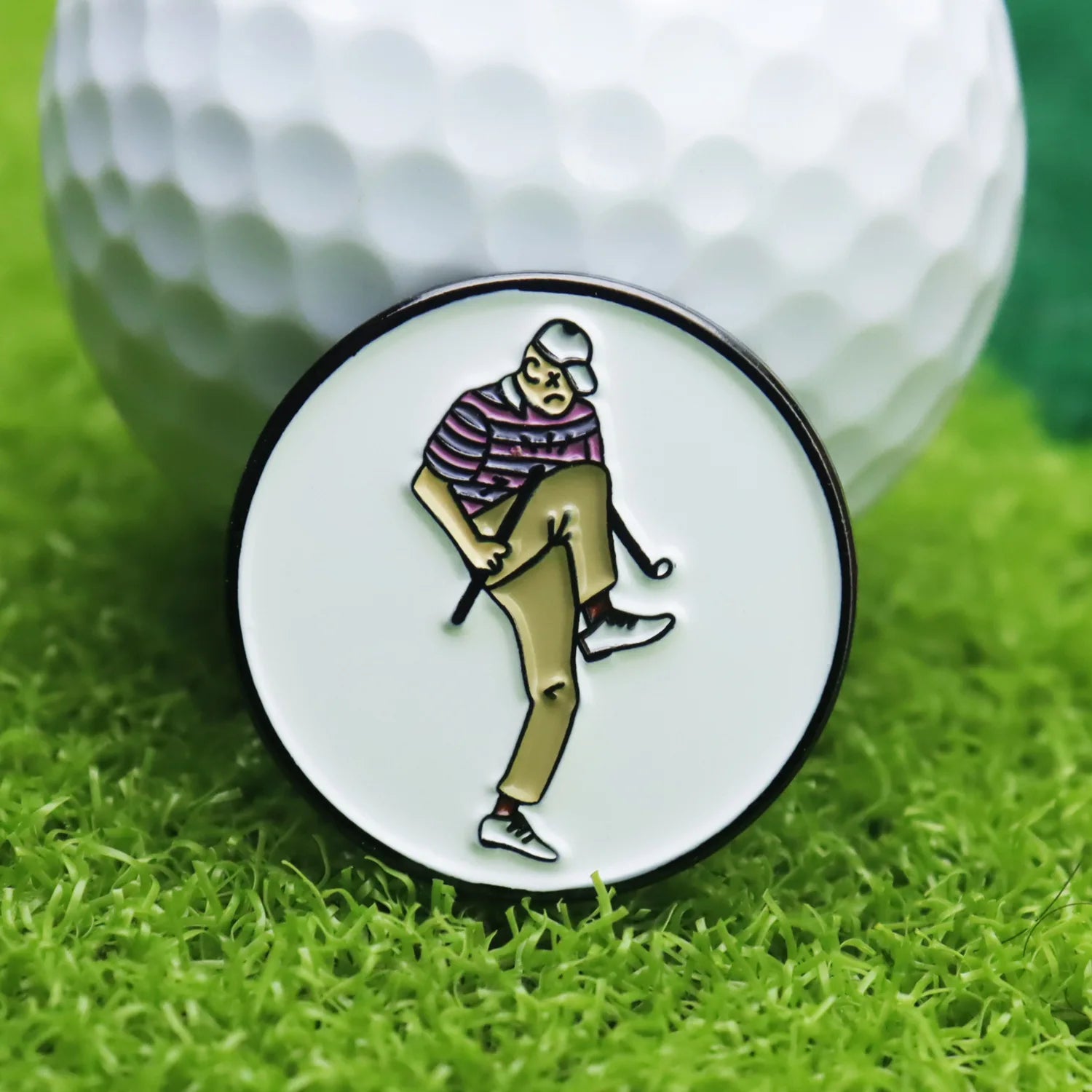 angry golfer enamel ball marker close up on grass