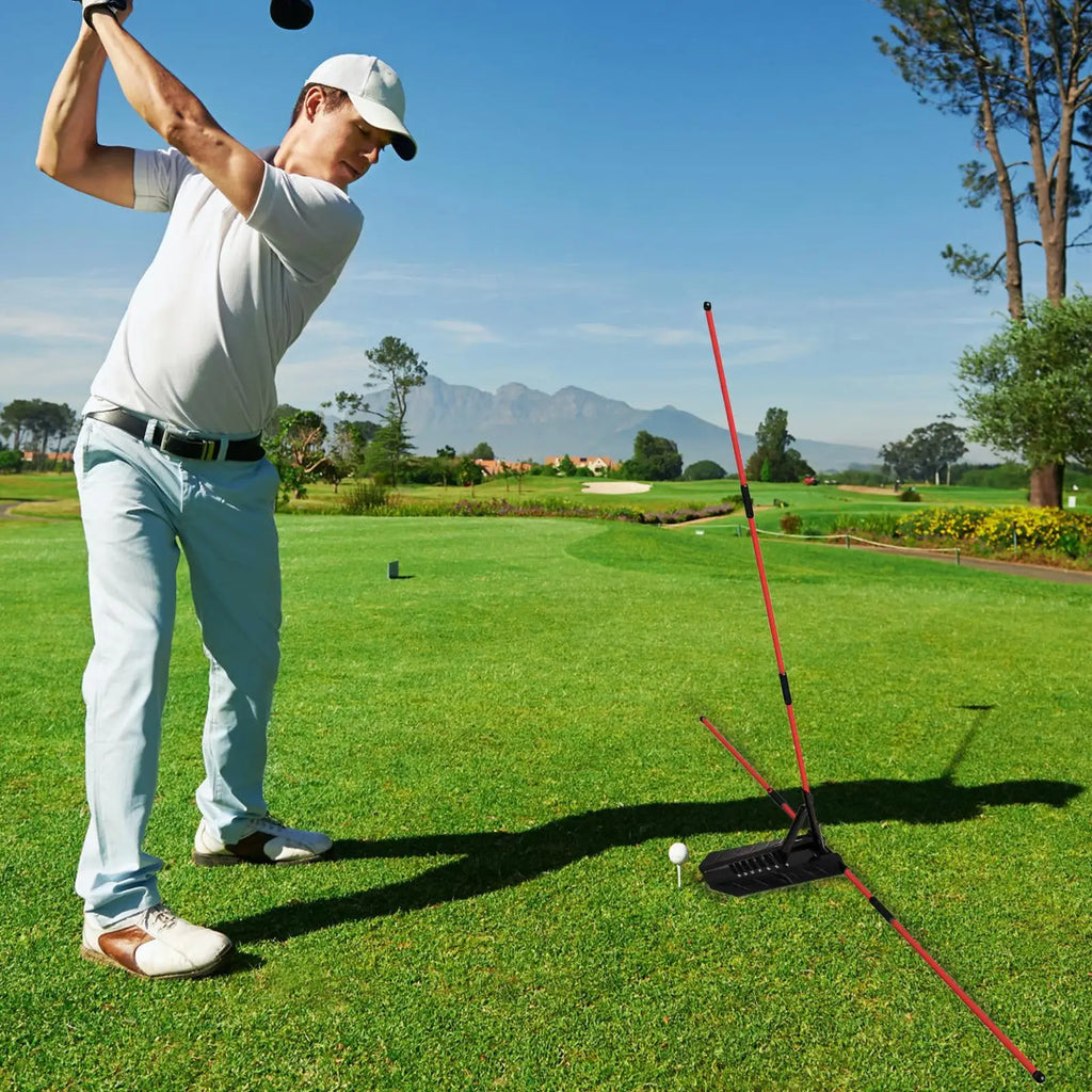 Golf alignment sticks UK - Man playing golf on a green course with mountains in the background