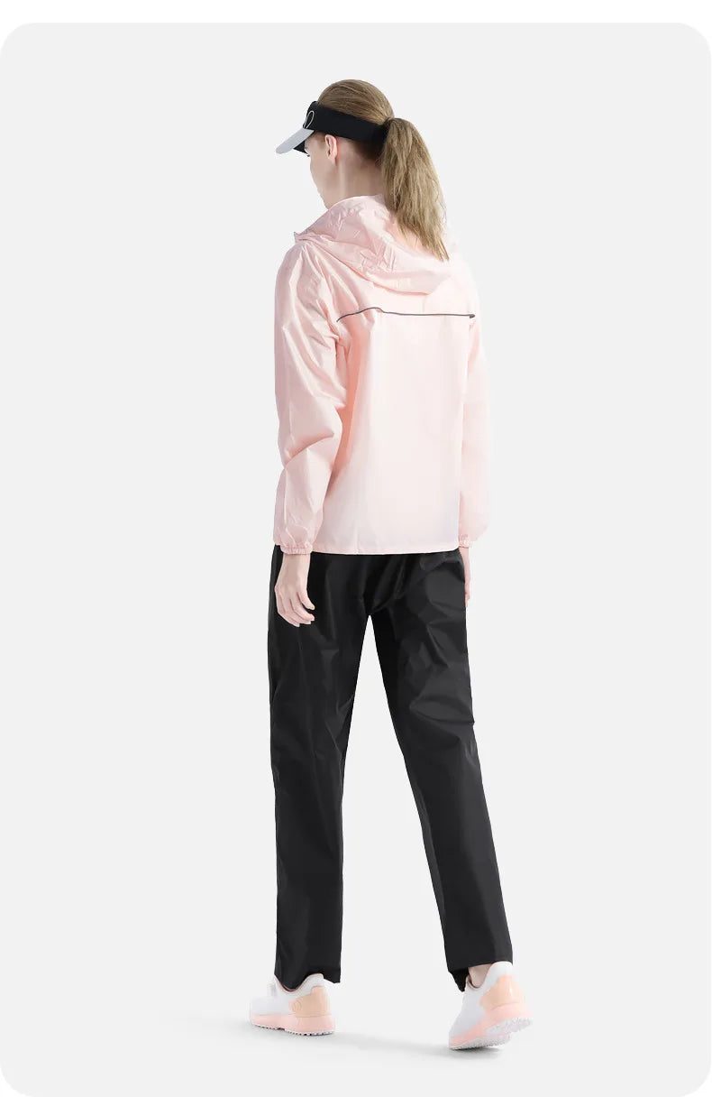 Person wearing a light pink jacket and black pants on a white background