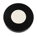Round black object with a white center on a white background
