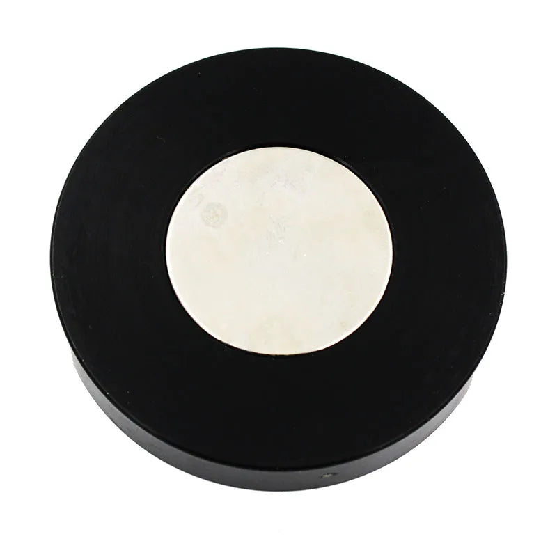 Round black object with a white center on a white background