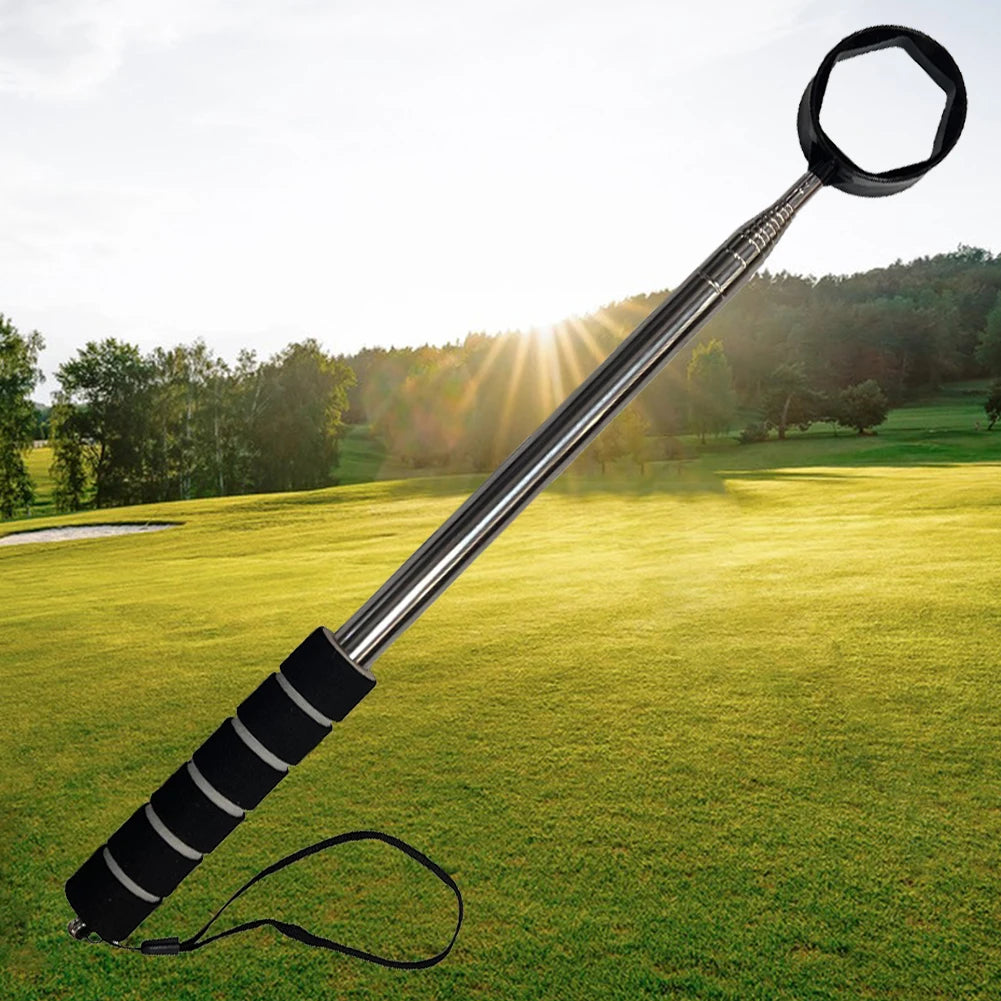 Golf club with a black handle on a golf course with trees and sun in the background