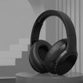 Black Bluetooth wireless earphones on a gray background with text about the product.