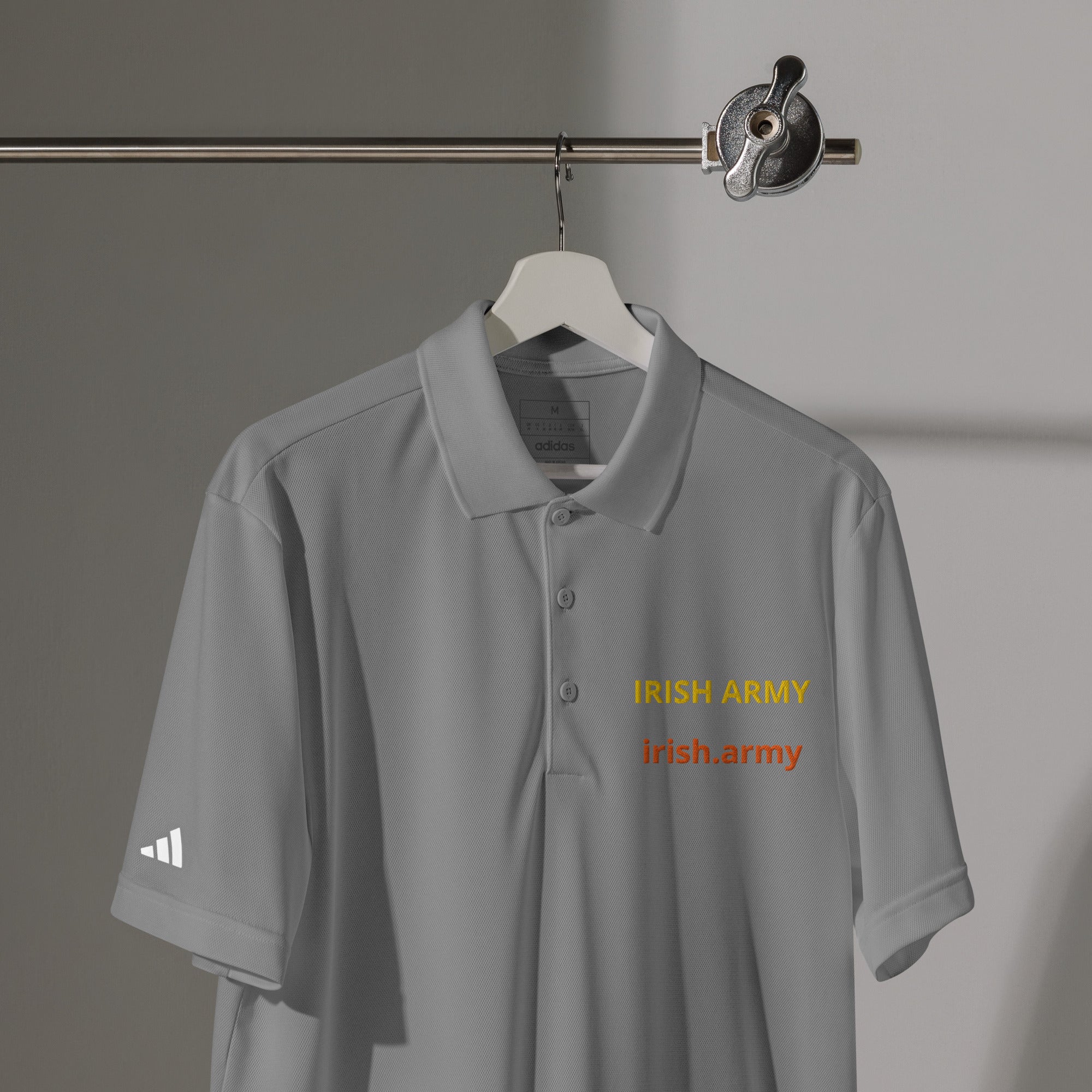 Gray polo shirt with 'Irish Army' text on a hanger against a gray background