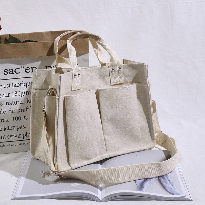 Women's Tote Bag in casual canvas, offering large capacity for shopping and on-the-go essentials. 